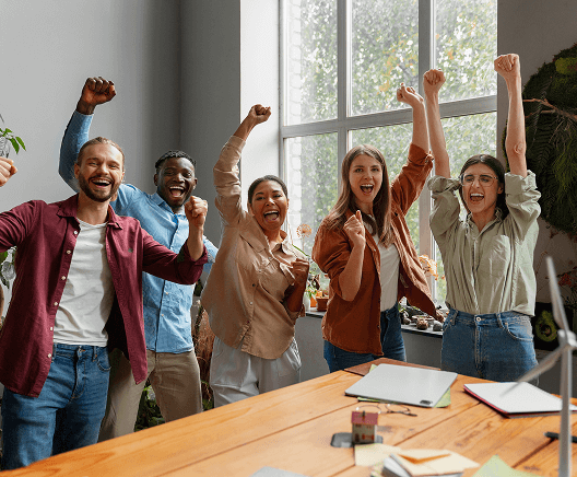 Team celebrating success with arms raised